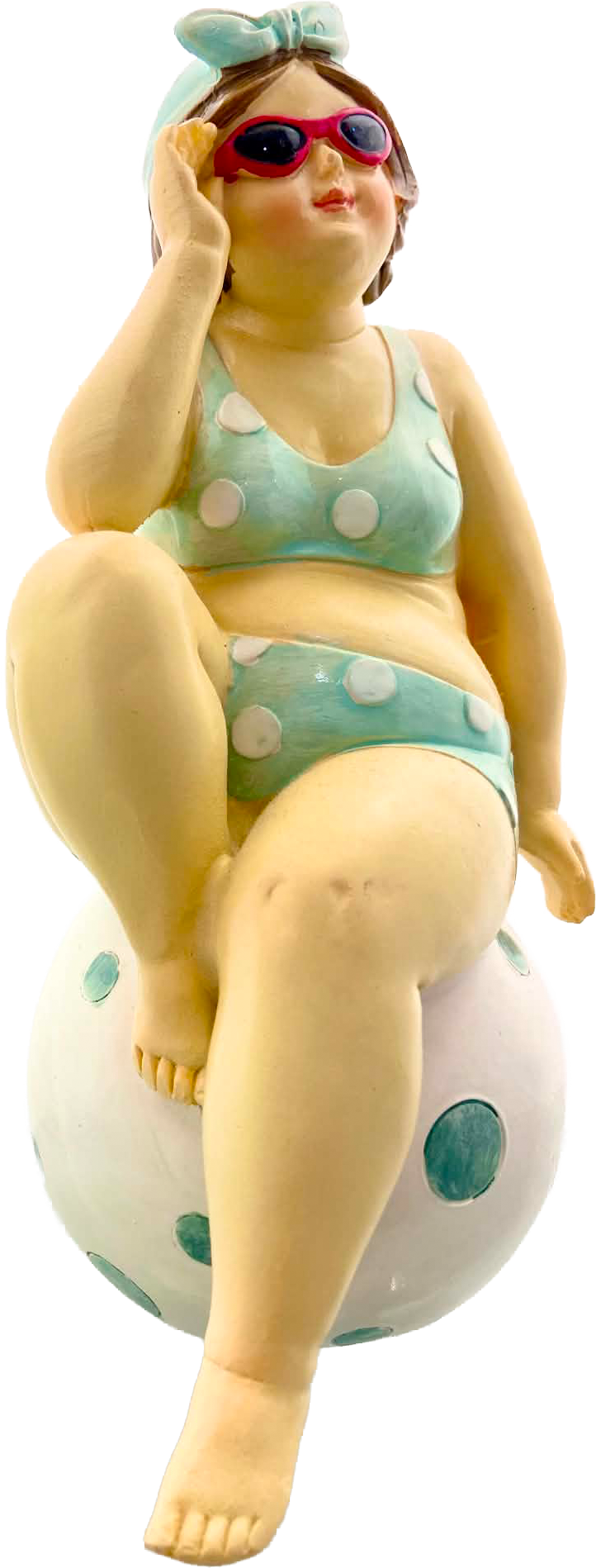 A small sunbather sculpture wearing red sunglasses and a turquoise polka-dot swimsuit on a white shelf.